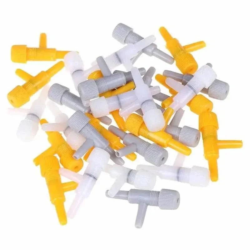 Pile of yellow, white, and gray plastic air valves.