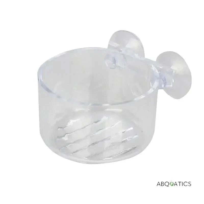 Clear plastic aquarium feeding cup with suction cups.