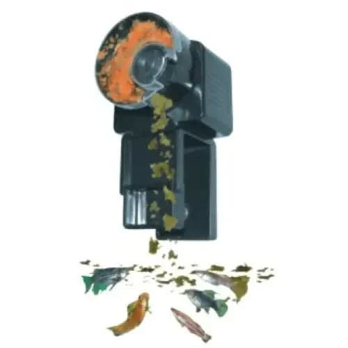 Automatic fish feeder dispensing food.