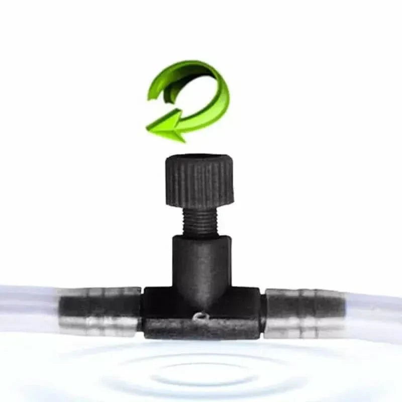 Black T-valve with adjustable knob and green rotation arrow.