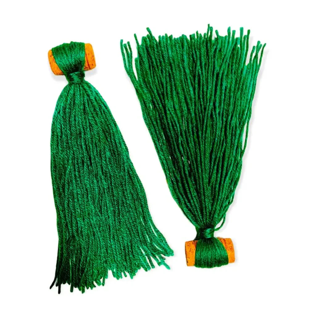 Two green yarn tassels.