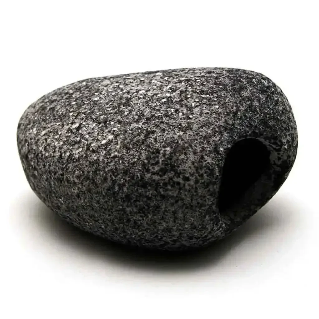 Dark gray, porous rock with a hole.