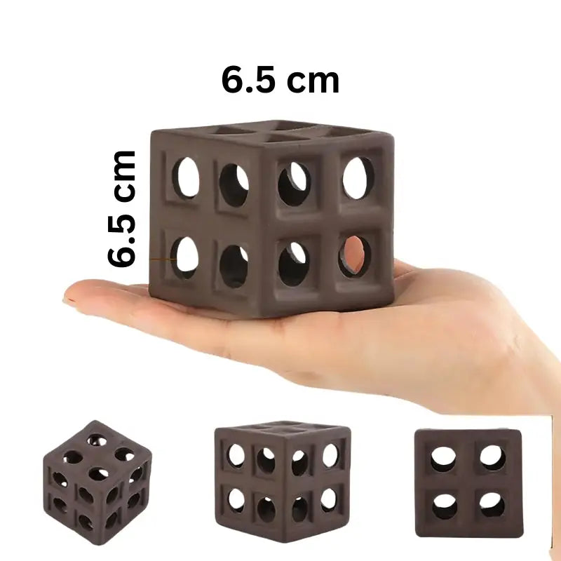 Brown ceramic cube with circular holes.