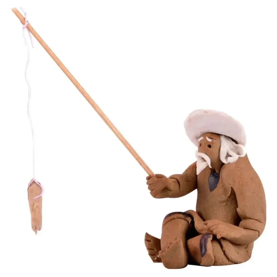 Clay figurine of an old man fishing.