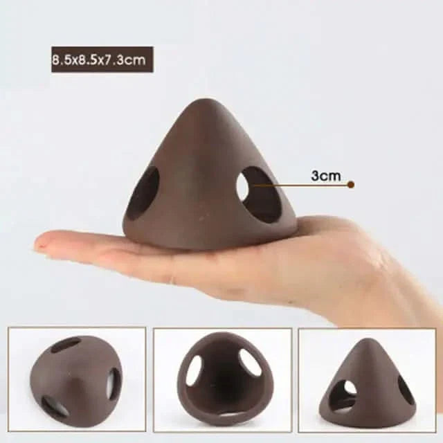 Brown triangular pet hideout with holes.