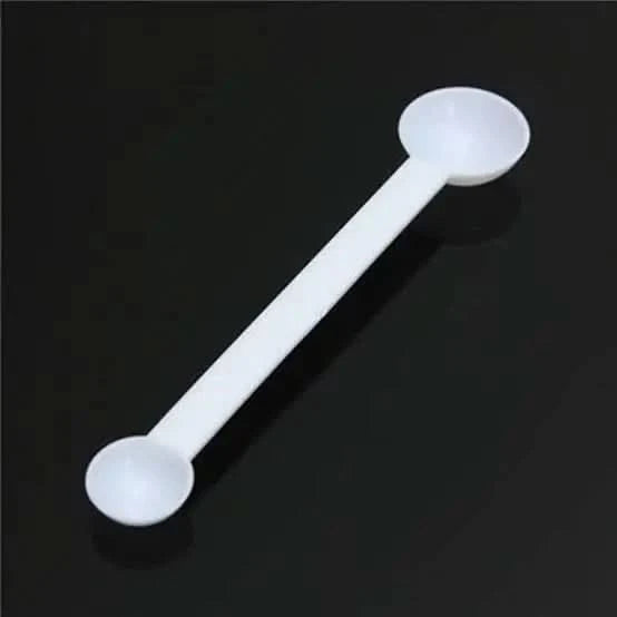 White double-ended measuring spoon.
