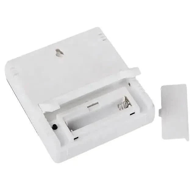 White digital thermometer with open battery compartment.