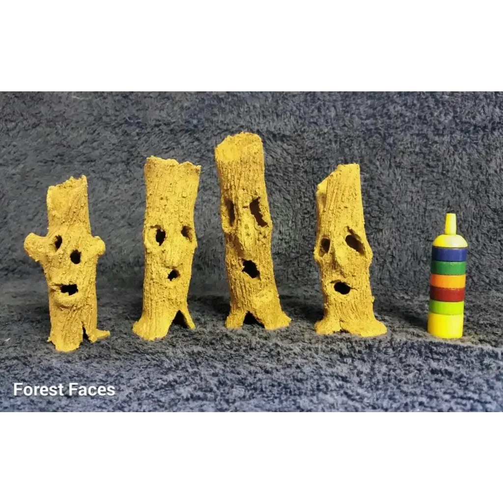 Four tree-like face sculptures.