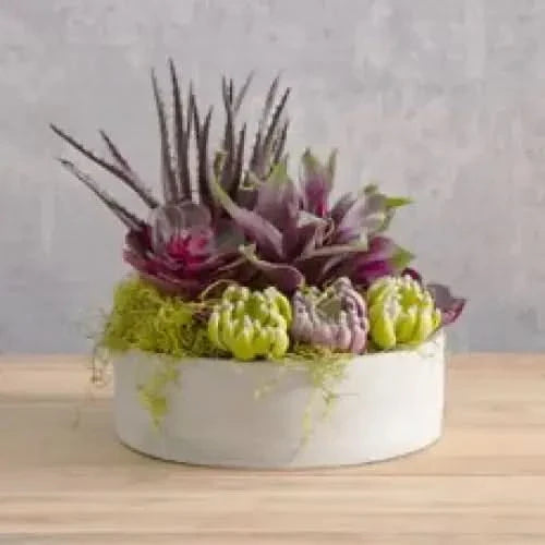 Floral arrangement in a white pot.