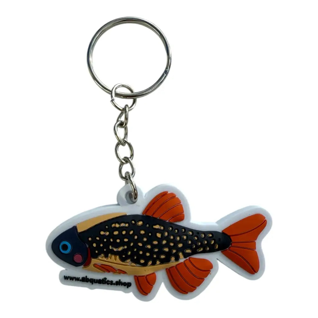 Fish-shaped keychain with orange fins and black spots.