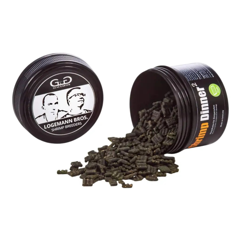 Two open black containers of shrimp food pellets.