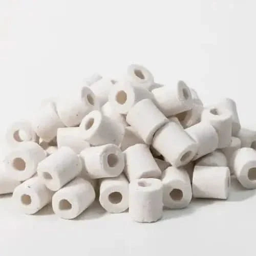 Pile of white ceramic filter rings.