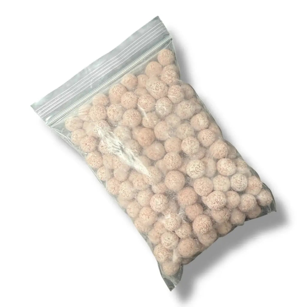 A transparent plastic bag filled with light-colored, spherical, porous ceramic filter media.