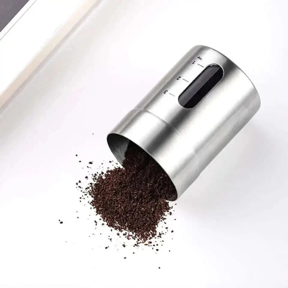 Stainless steel coffee bean container with measurement markings.