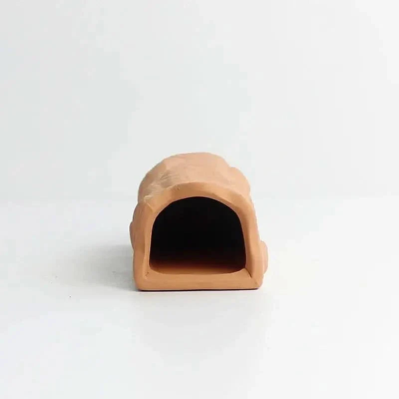 Terracotta cave-like aquarium decoration.