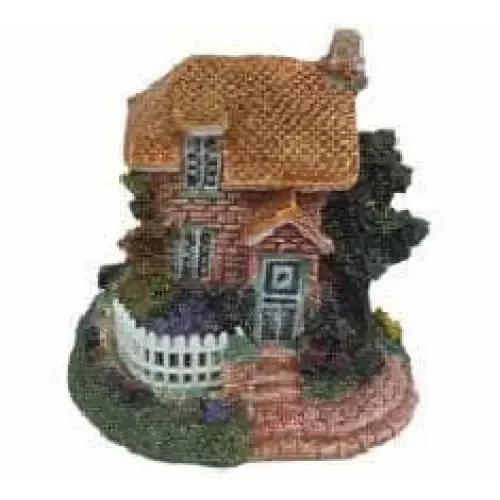 Miniature thatched-roof cottage.