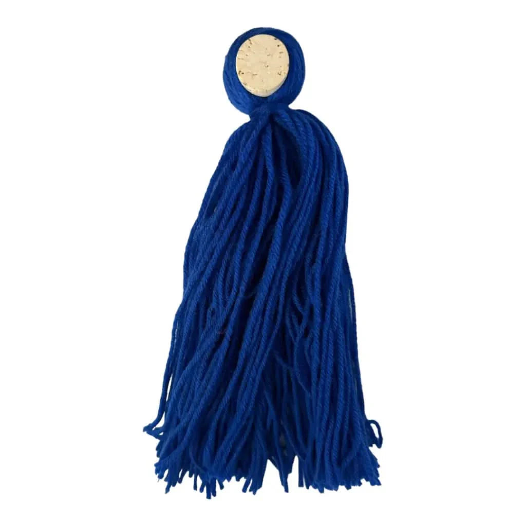Blue yarn tassel with cork top.