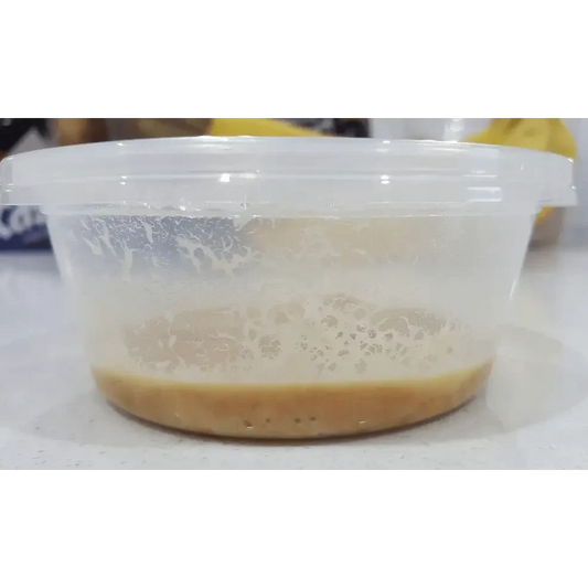 Tan liquid in a clear plastic container.