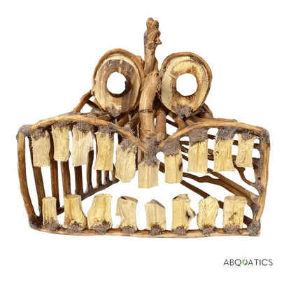 Wooden aquarium decoration resembling a face.