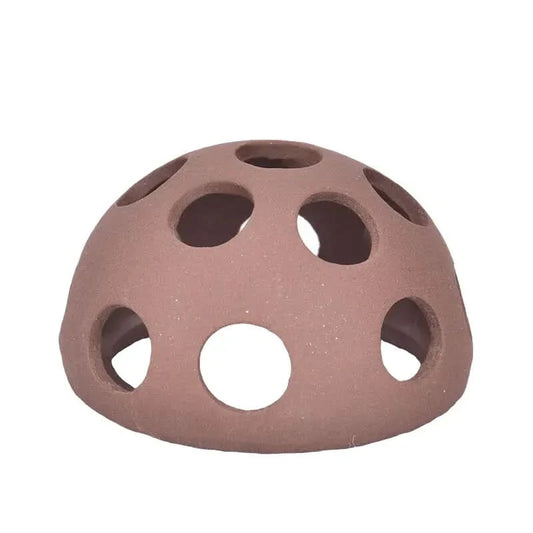 Dome-shaped terracotta aquarium decoration with holes.