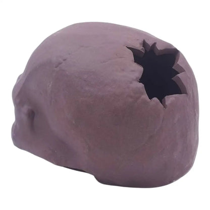 Maroon skull with jagged hole.