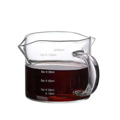Glass measuring pitcher with handle.