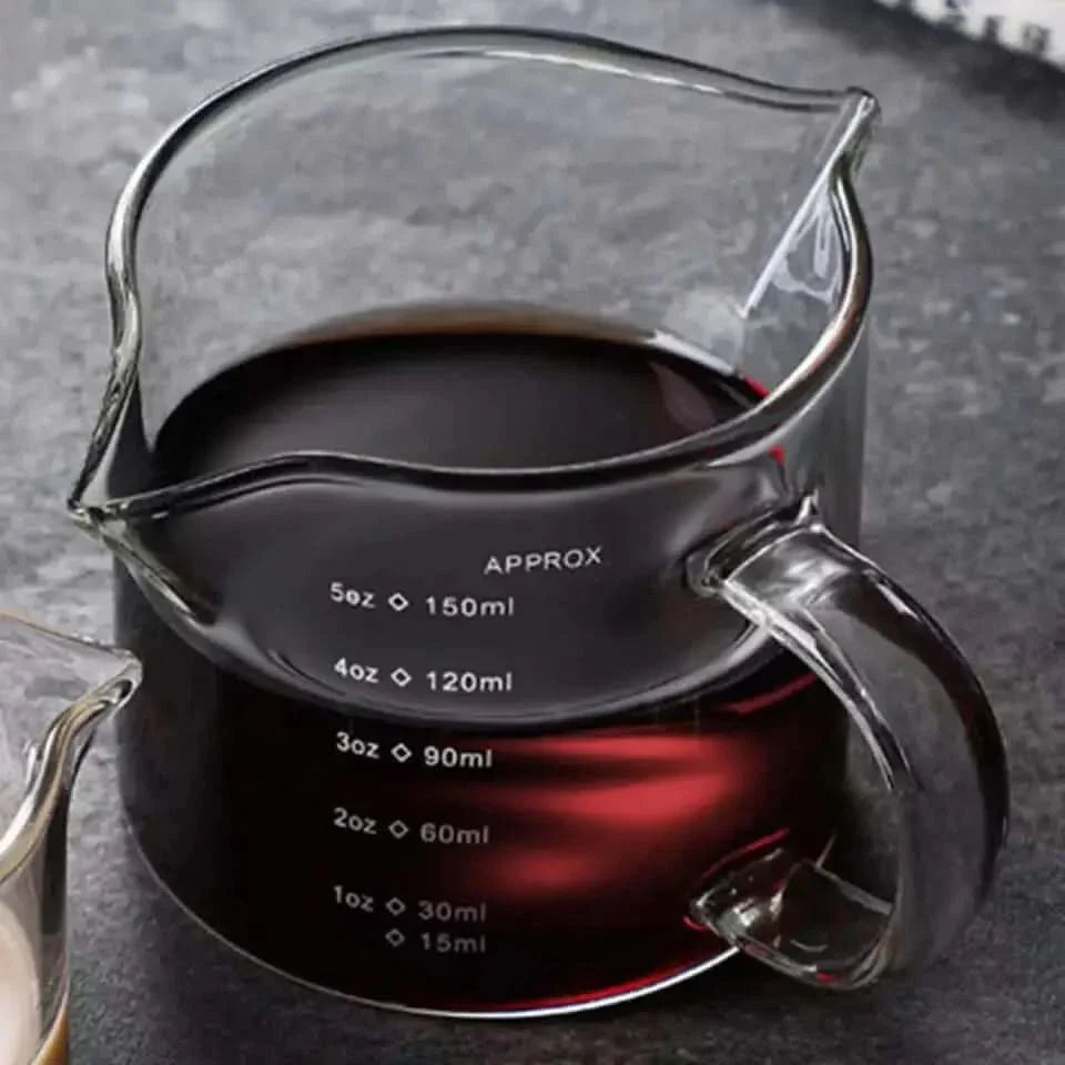Glass measuring pitcher with handle.
