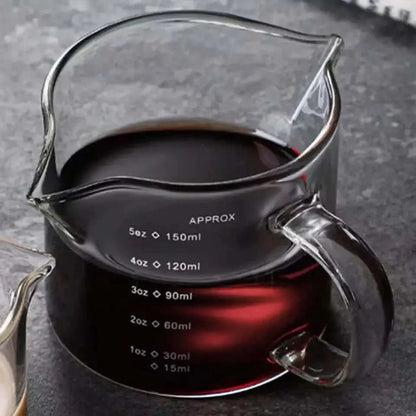 Glass measuring pitcher with handle.