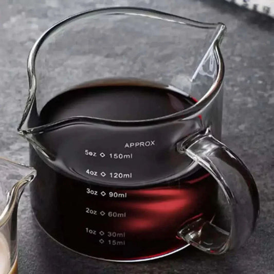 Glass measuring pitcher with handle.