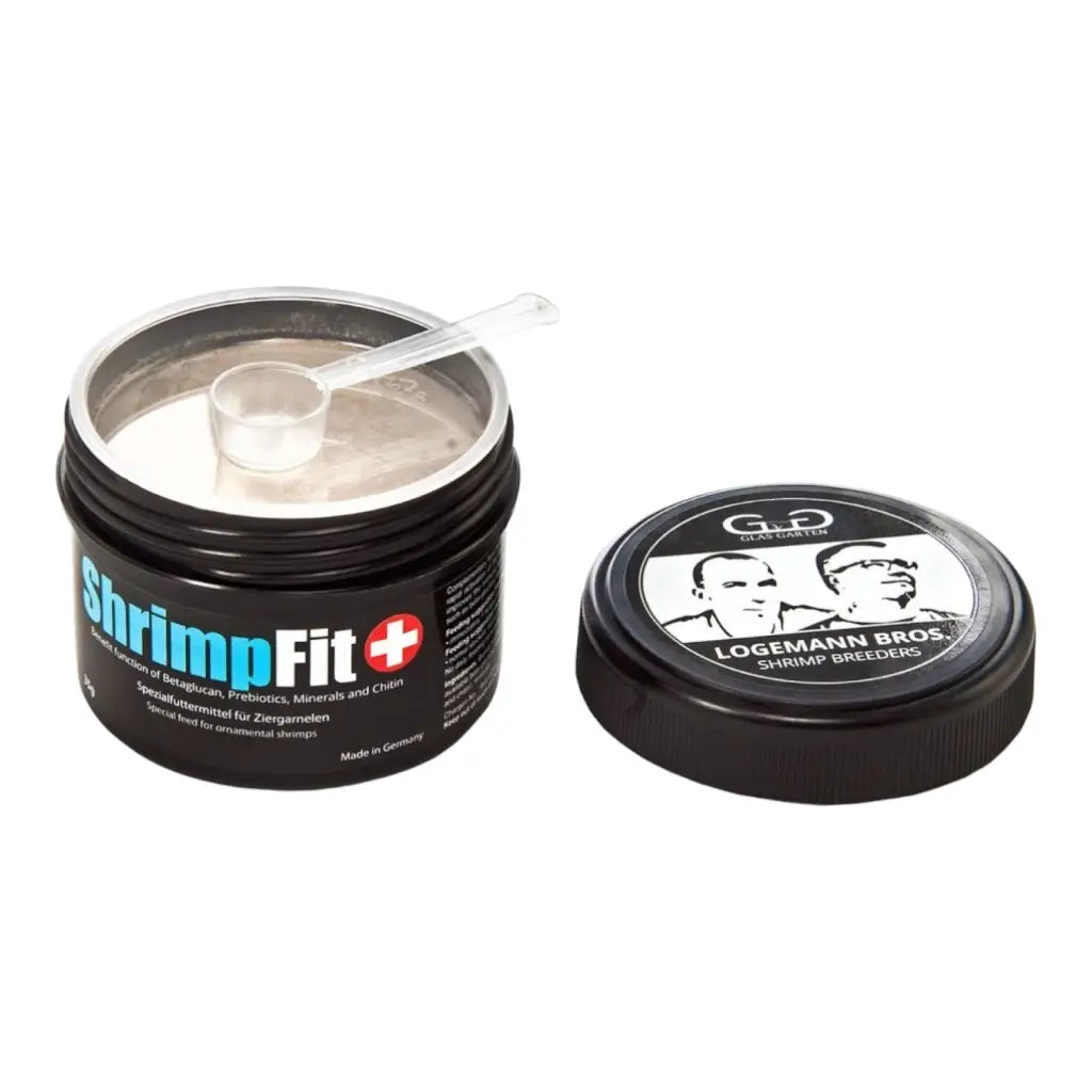 An open container of powdered shrimp food with a measuring scoop and a closed lid.