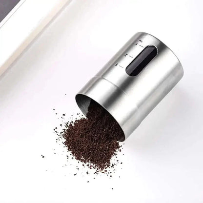 Stainless steel coffee bean container with measurement markings.
