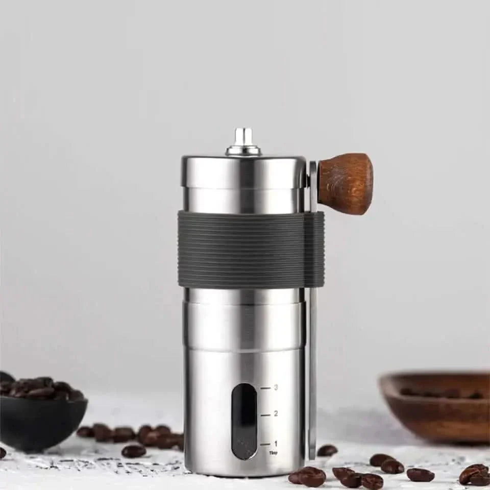 Silver manual coffee grinder with wooden handle.