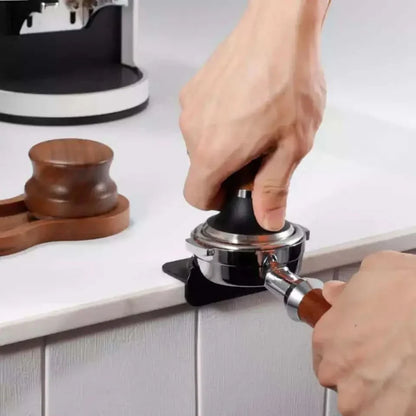 Espresso tamper pressing portafilter.