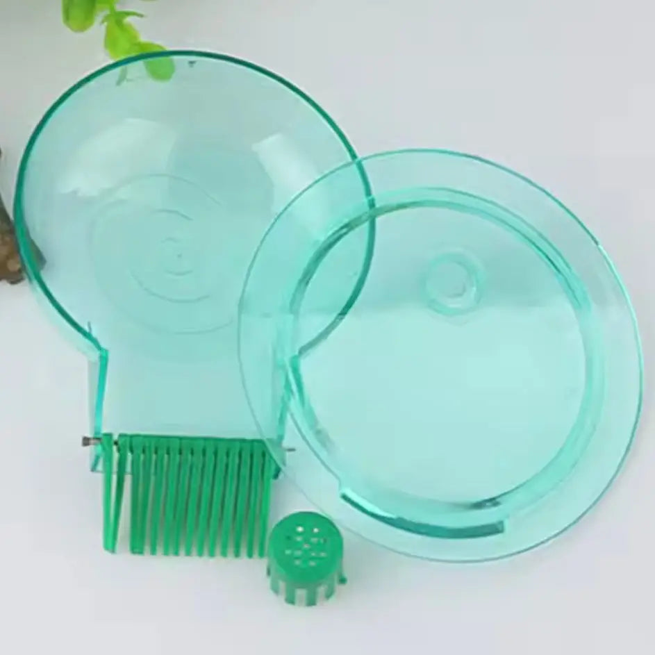 Green plastic pet comb with rounded head and small brush teeth, designed for grooming cats or dogs.