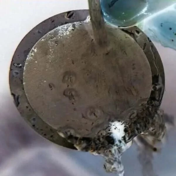 Circular metal object with dripping liquid.