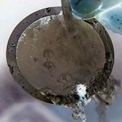 Circular metal object with dripping liquid.