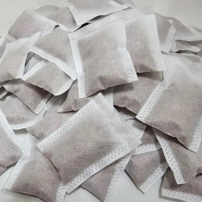 Pile of white tea bags.