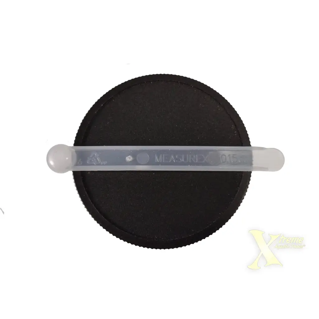 Black jar lid with plastic measuring spoon.