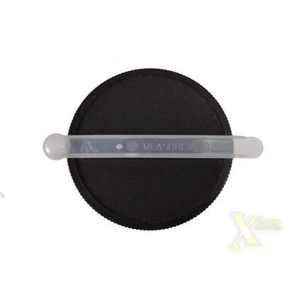 Black jar lid with plastic measuring spoon.
