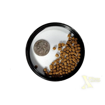 Round container with fish food and a dime.